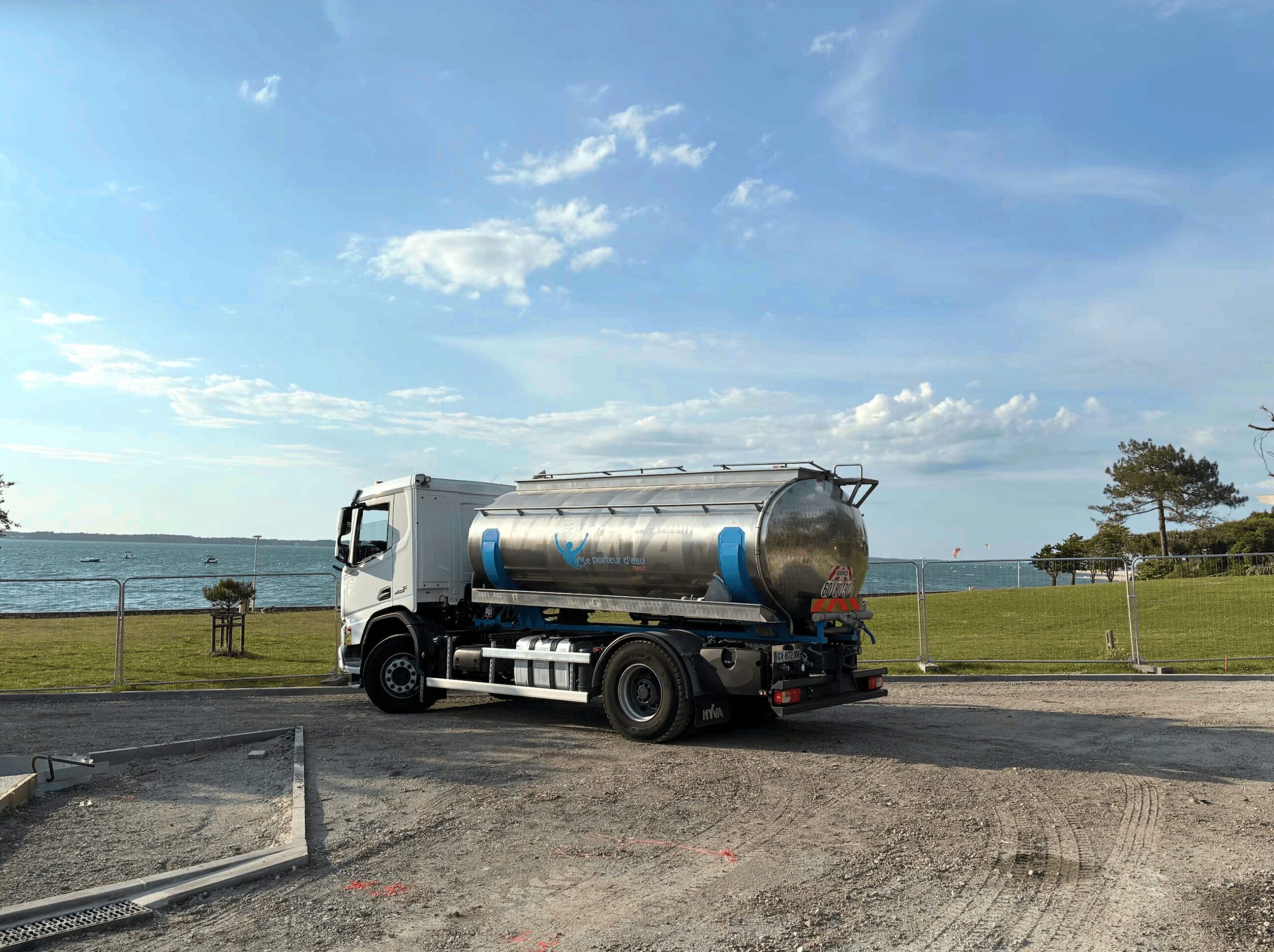 Camion-citerne inox Le Porteur d'Eau JMGC stationné au bord de l'eau en Gironde